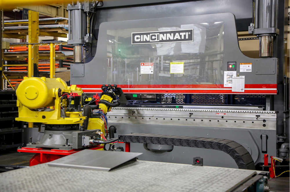 Figure 1: Cincinnati Inc. provides laser cutting systems, automation, press brakes, shears, conveyor systems, powder metal systems, and additive manufacturing systems. Over the last 100 years, the U.S. company has supplied more than 50,000 metal fabrication machines. This press brake from Cincinnati Inc. (CI) bends sheet metal. The edges of the material engage with motorized edges of CI’s Cartesian backgauge. Courtesy: Cincinnati Inc. 